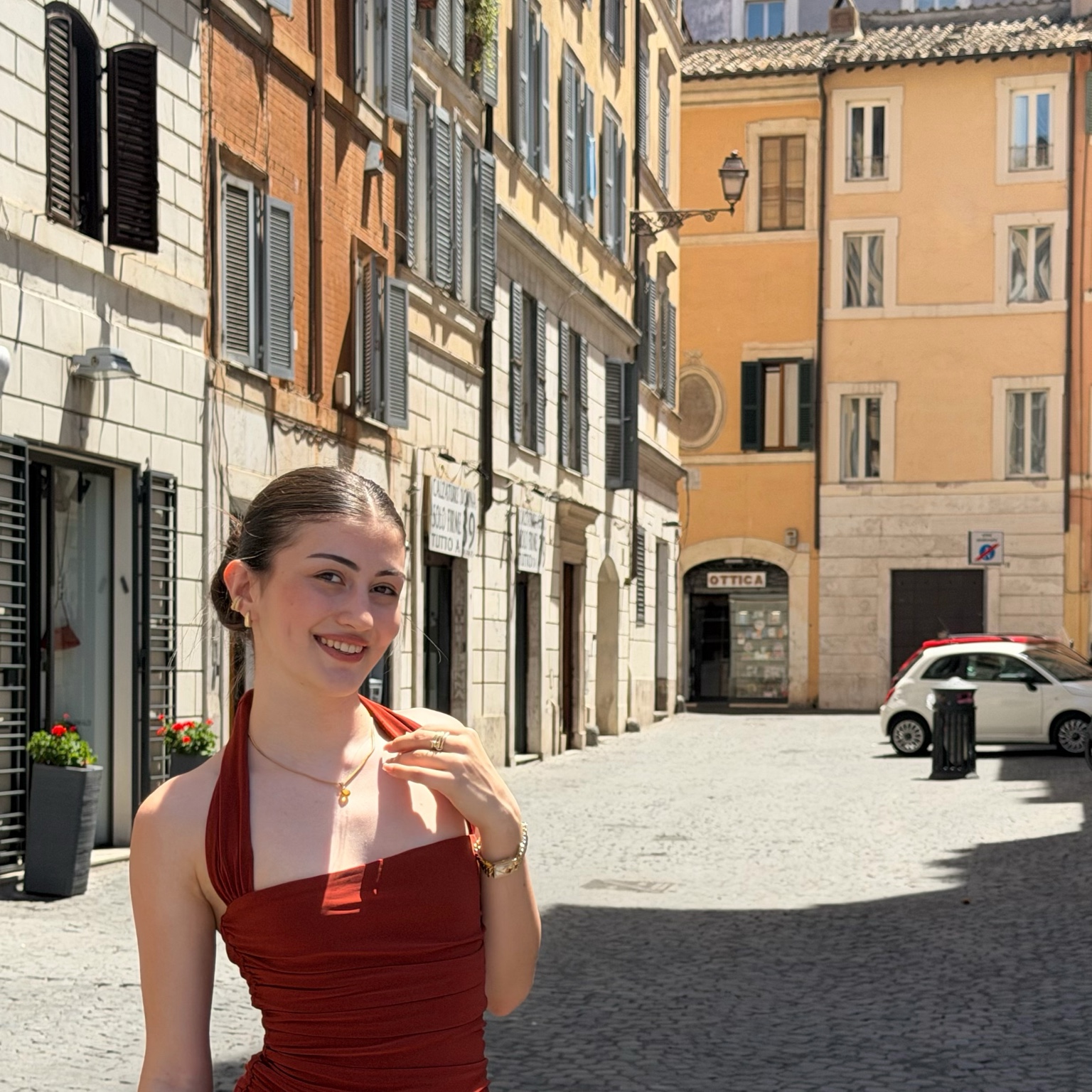 Gizem Afyonluoğlu standing on a sunlit street